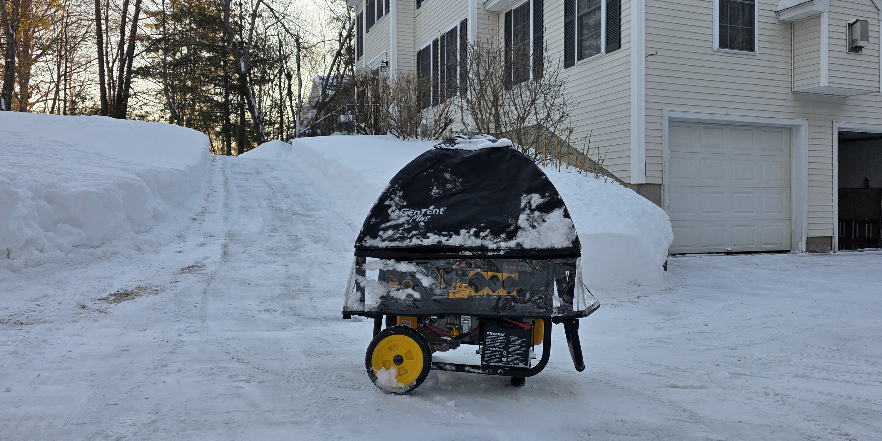 GenTent Universal Clamp Kit protecting a Firman H07553 open frame generator running in blizzard snow